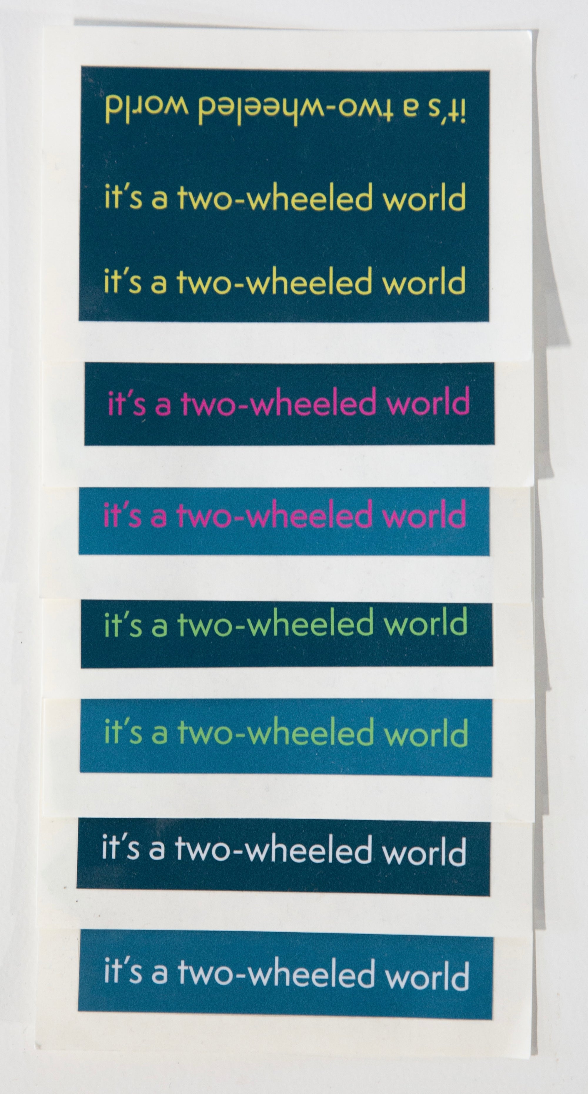 IT'S A TWO-WHEELED WORLD Tri-line Stickers